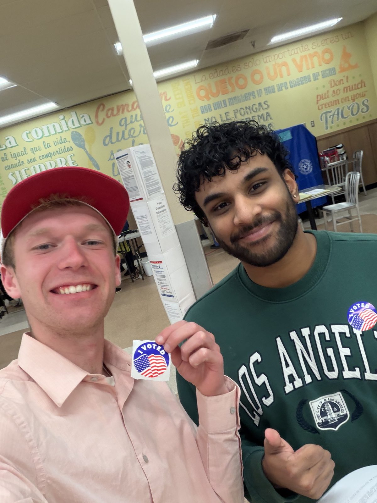 Aidan Isaac and a supporter with I Voted stickers